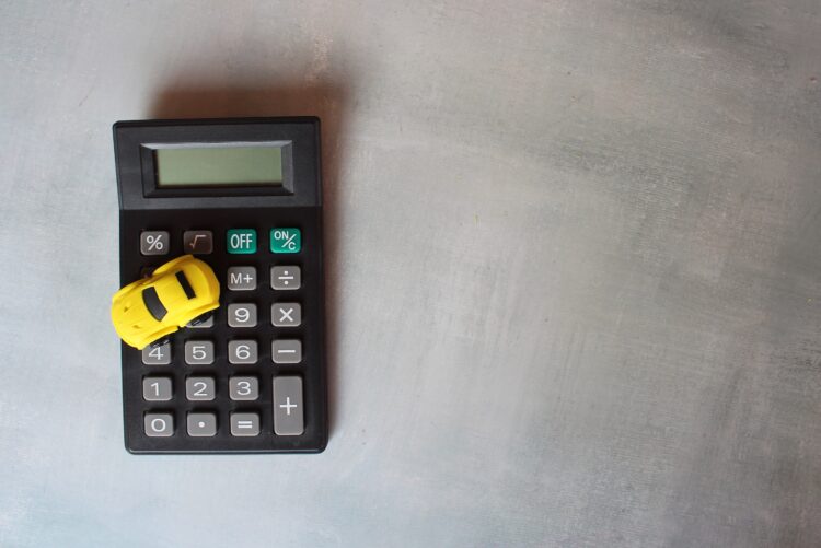 Top view image of toy car and calculator. Car, transportation cost calculation concept.  Copy space for text